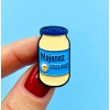 Pin made of tin depicting a jar of mayonnaise.