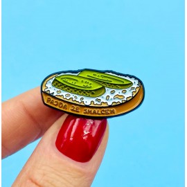 Pin made of tin depicting a slice of bread with lard.