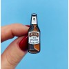 Pin in the shape of a beer bottle made of tin