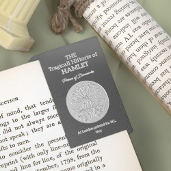 A metal bookmark inspired by the first edition of "Hamlet" by William Shakespeare.